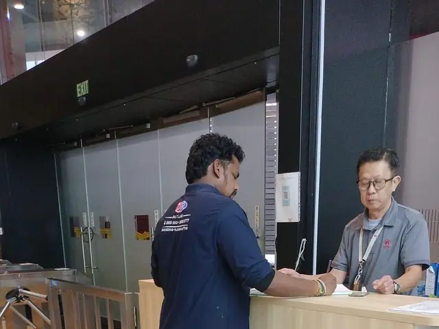 DJR plumber signing in at a building's front desk before starting work