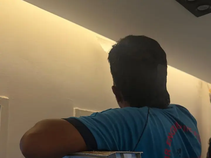 DJR plumber on a ladder working through a ceiling access hatch