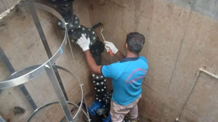 DJR technician working on pump valves inside a concrete pump pit